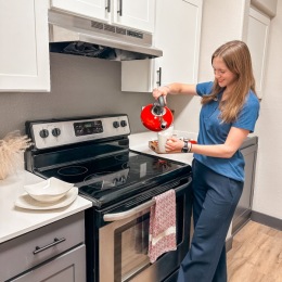 a person making tea in a kitchen