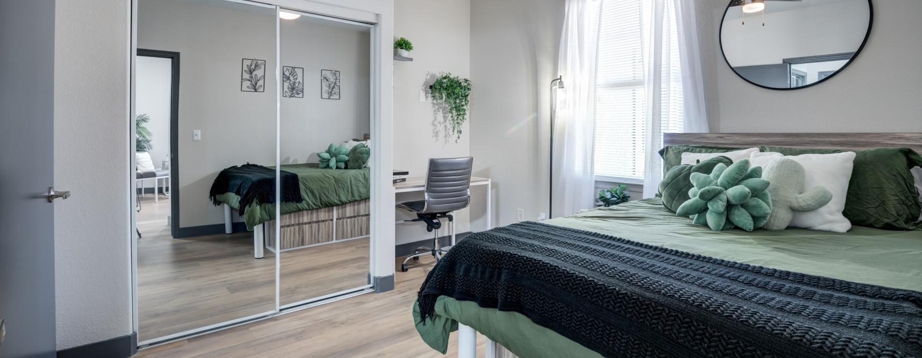 a bedroom with a large mirror