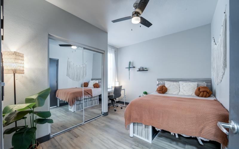 bright bedroom with ceiling fan