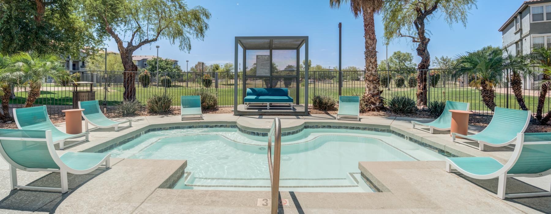 jacuzzi surrounded by lounge chairs