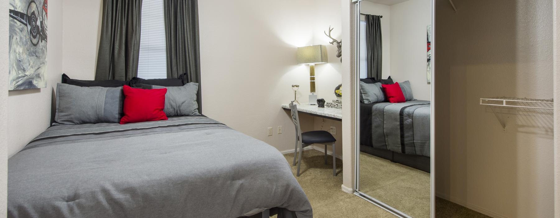 a bedroom with a bed and a fan