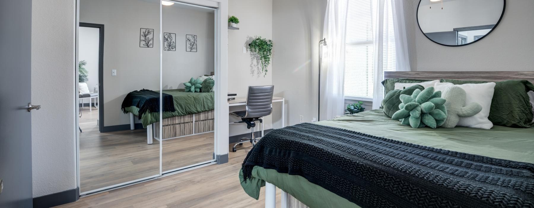 a bedroom with a large mirror